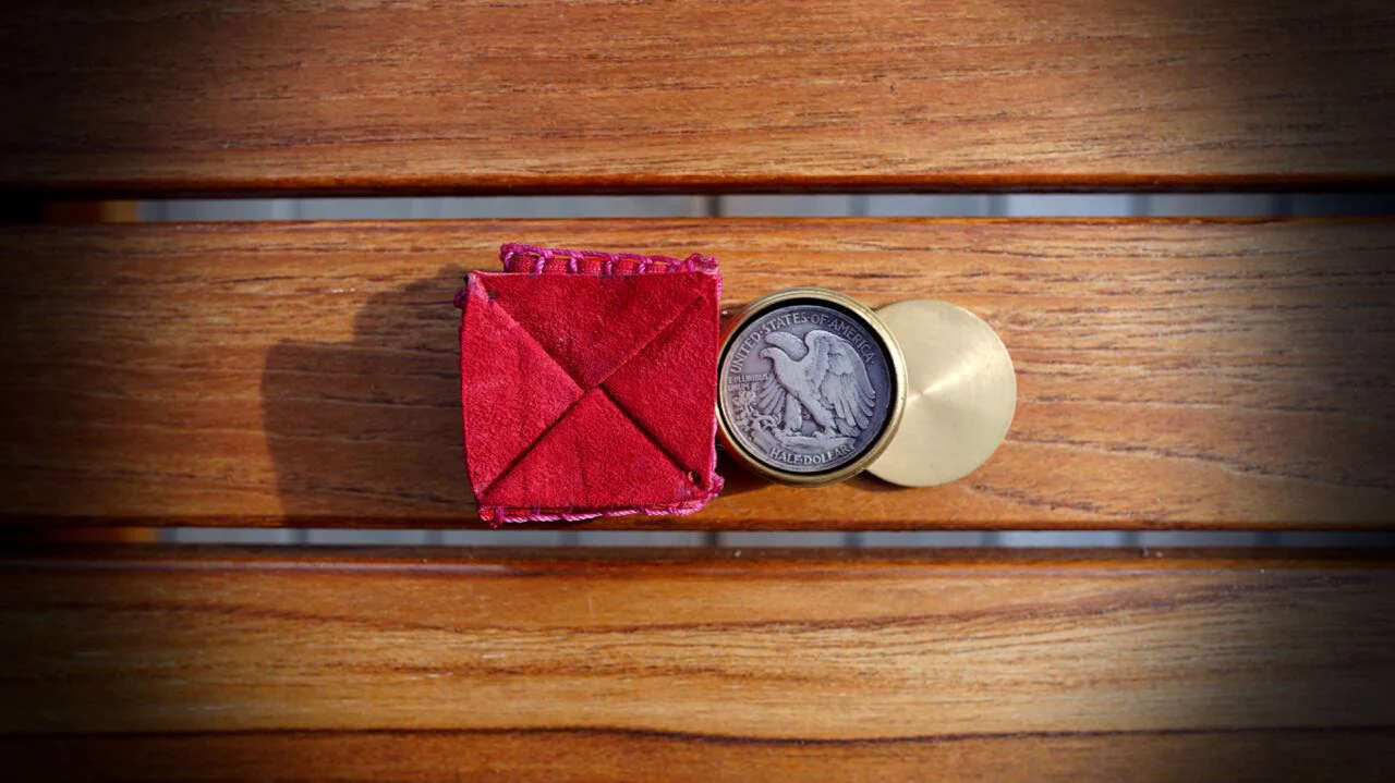 Coin Box Wallet by Jeff Copeland red shown from above on wooden surface