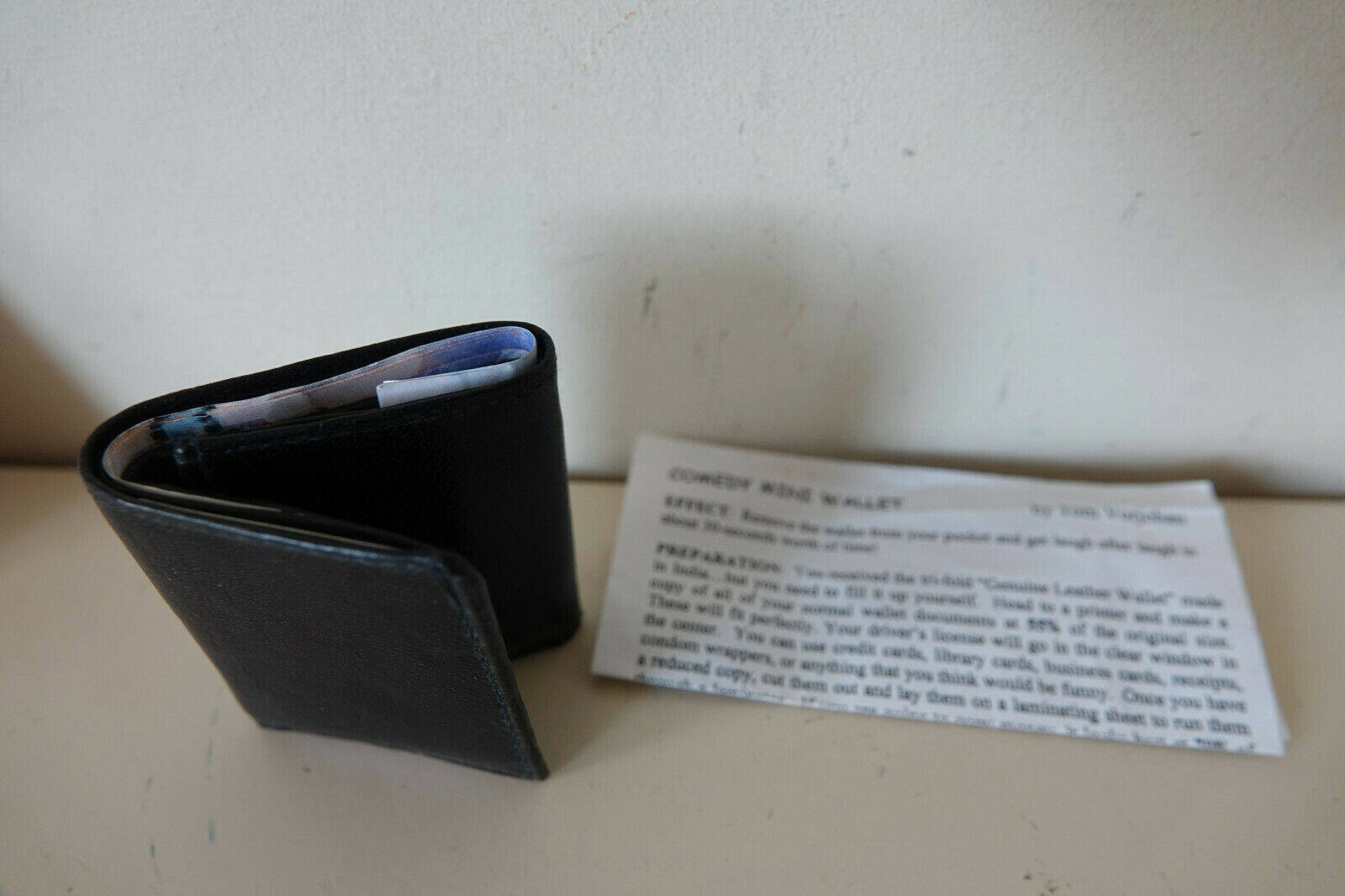 Comedy Mini Wallet by Tom Vorjohan closed next to instructions