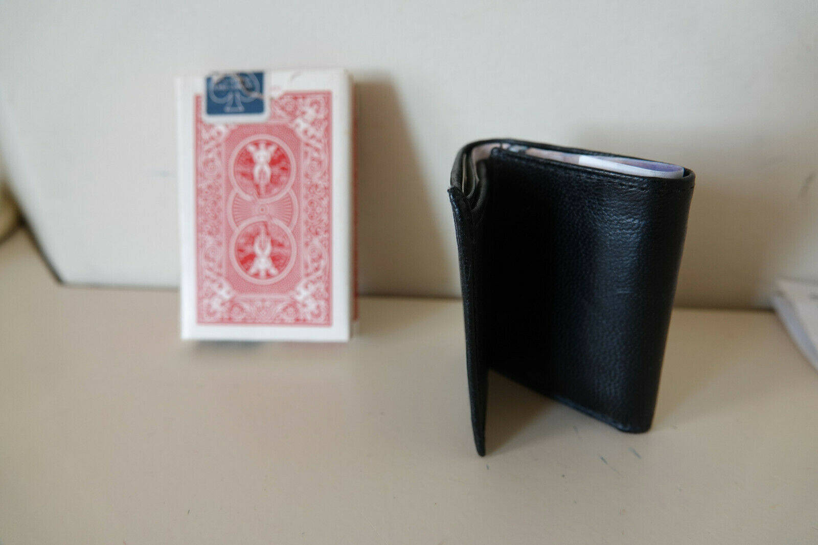 Comedy Mini Wallet by Tom Vorjohan next to a deck of cards