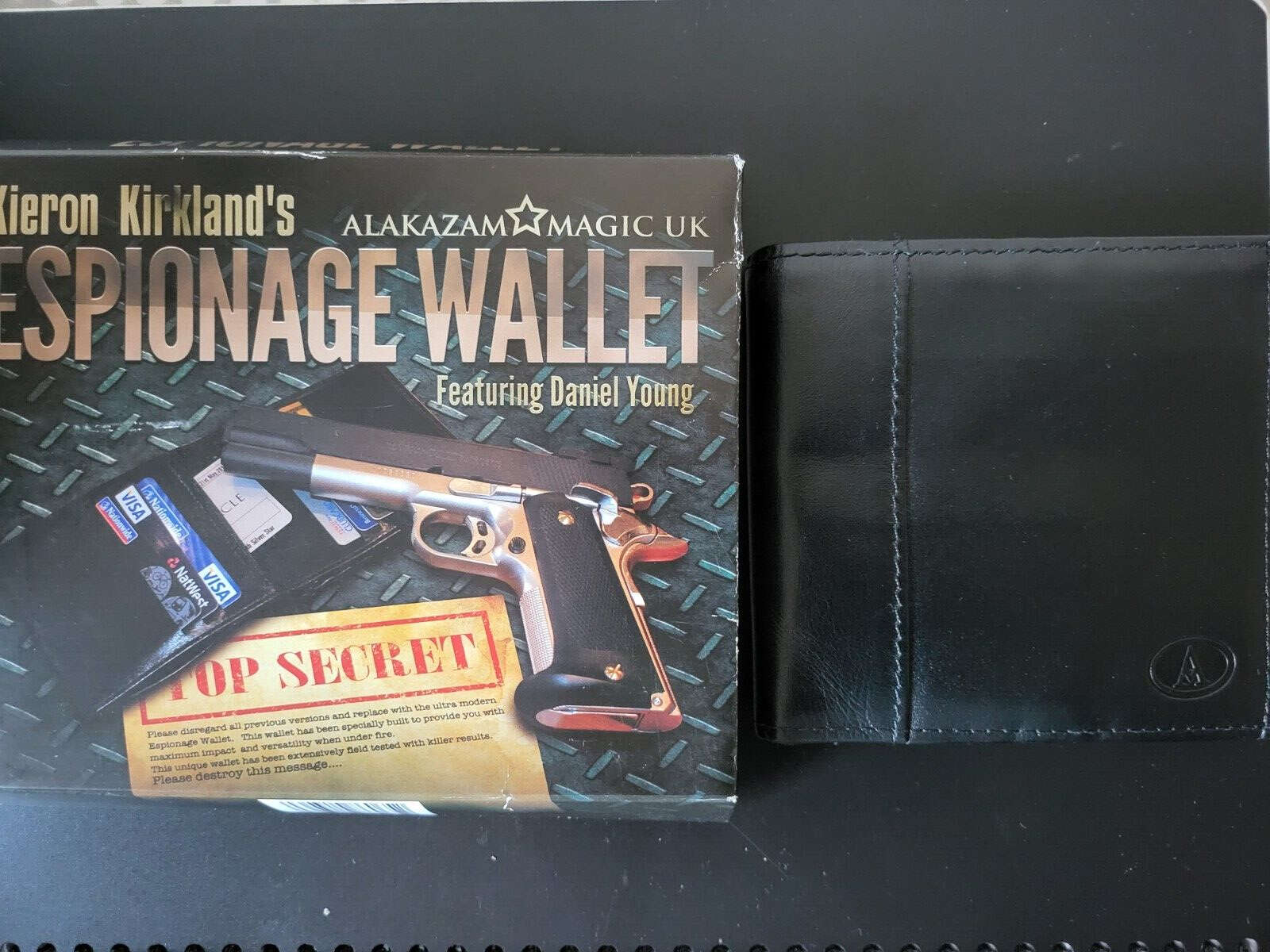 Espionage wallet by Alakazam next to box