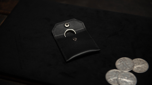 FPS Coin Wallet by Brent Braun and The Magic Firm with rings inside next to coins on magician's pad