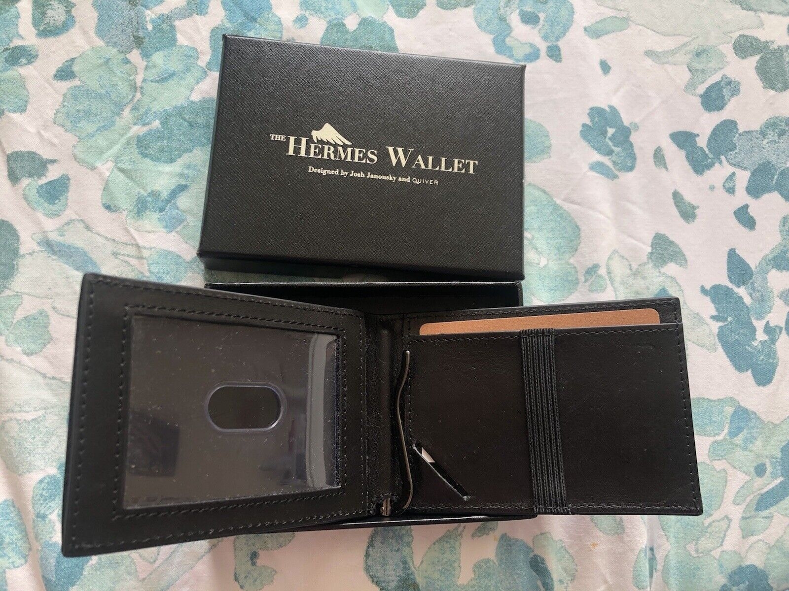 Hermes wallet layed flat next to box