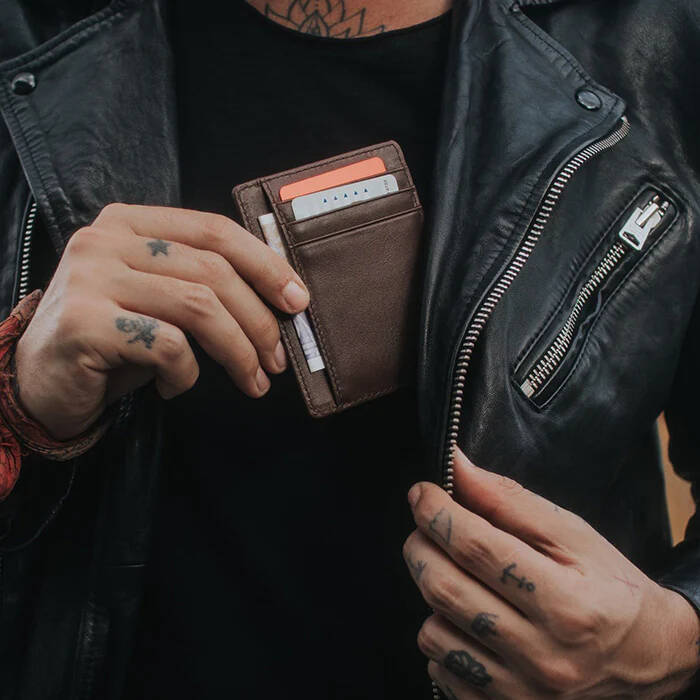 Brown Shadow Wallet by Dee Christopher held by man in leather jacket