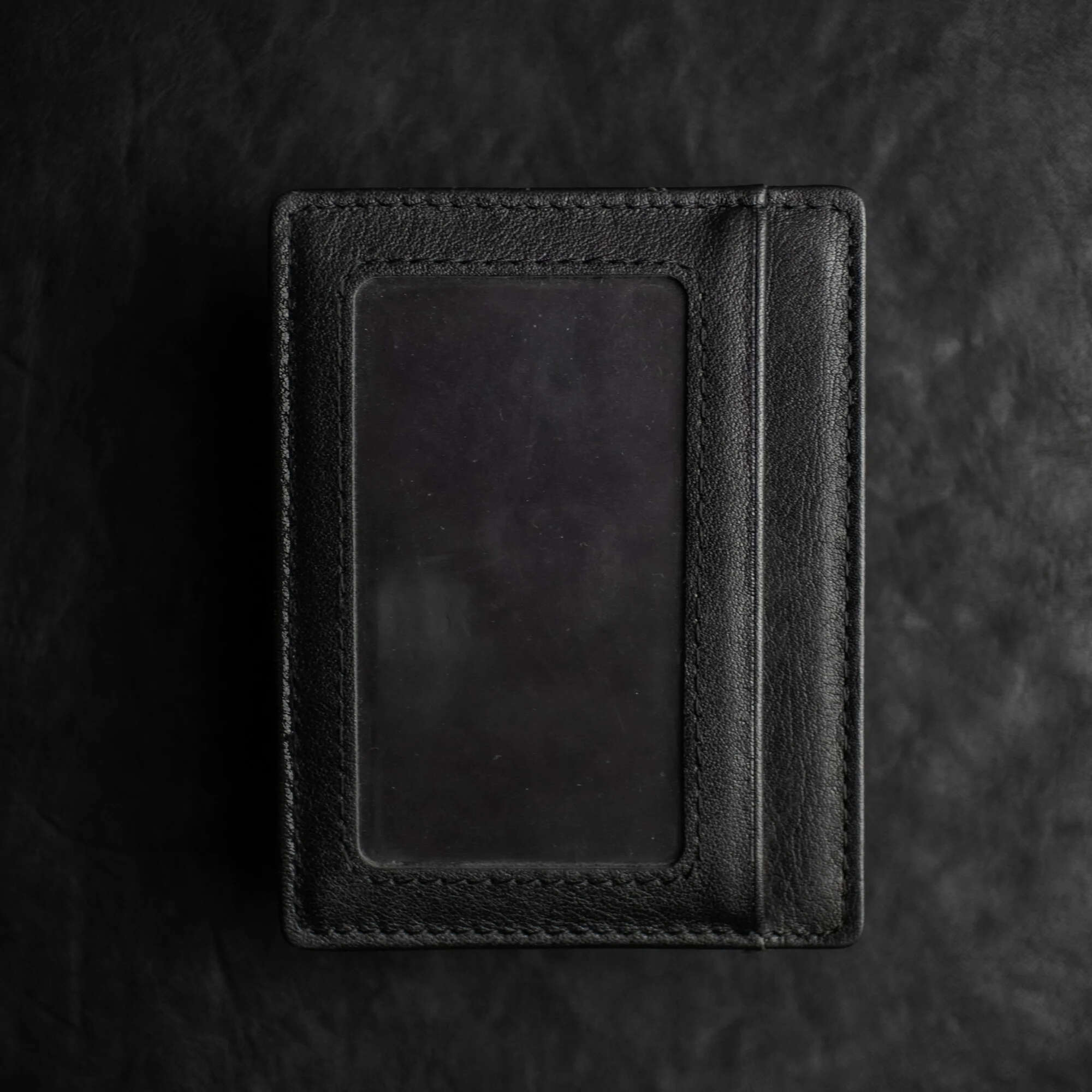Black Shadow Wallet by Dee Christopher on black surface showing ID Window
