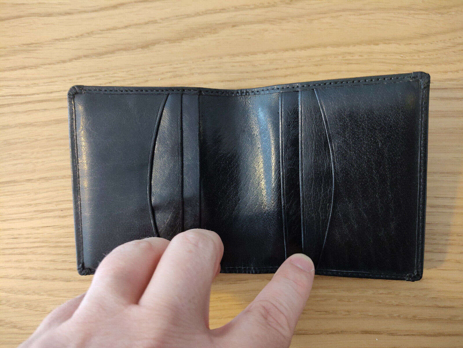 Sho-Gun Wallet by Jerry O’Connel & Propdog held open by hand on wooden surface