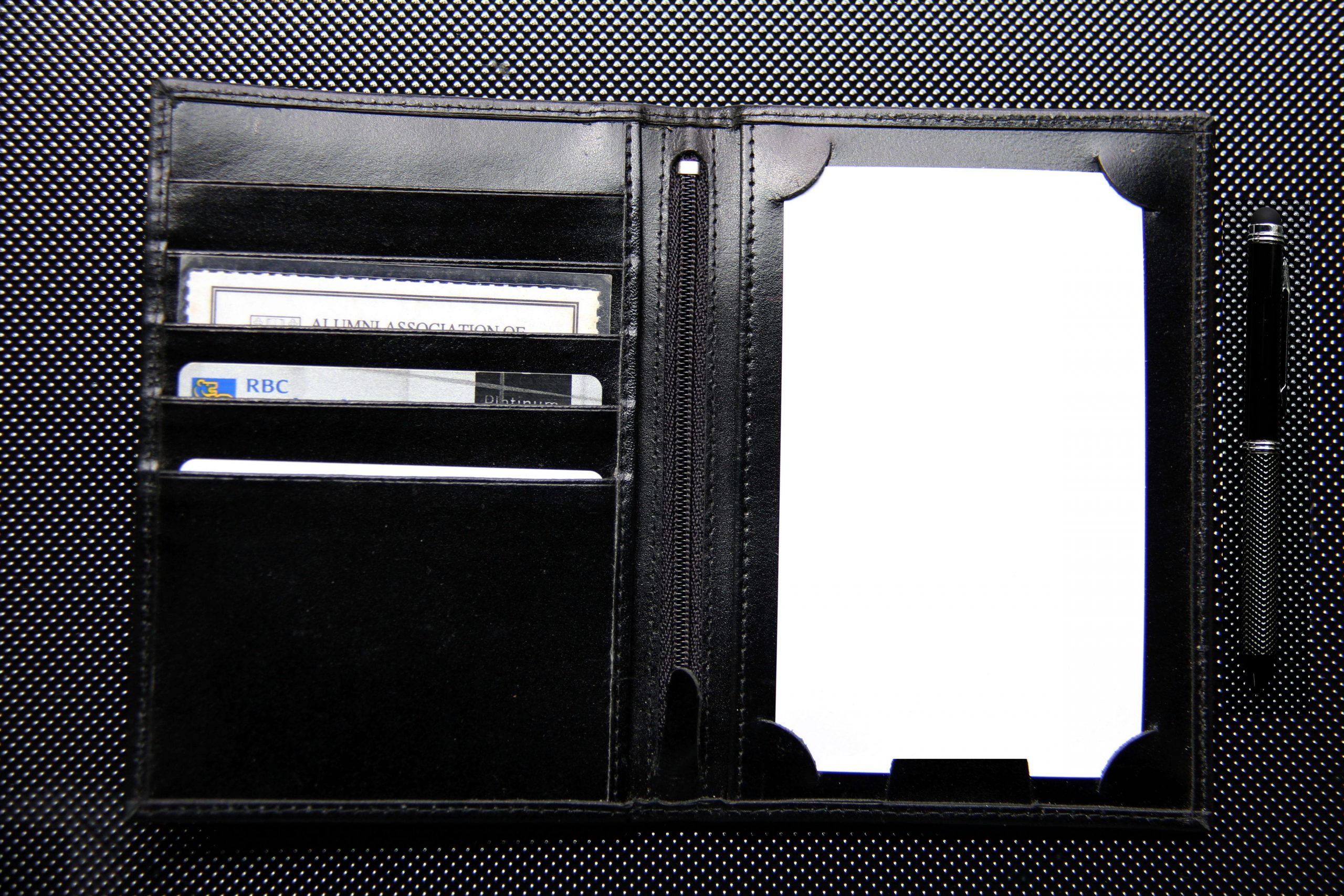 The Solstice Wallet by Christopher Taylor shown open on dark surface