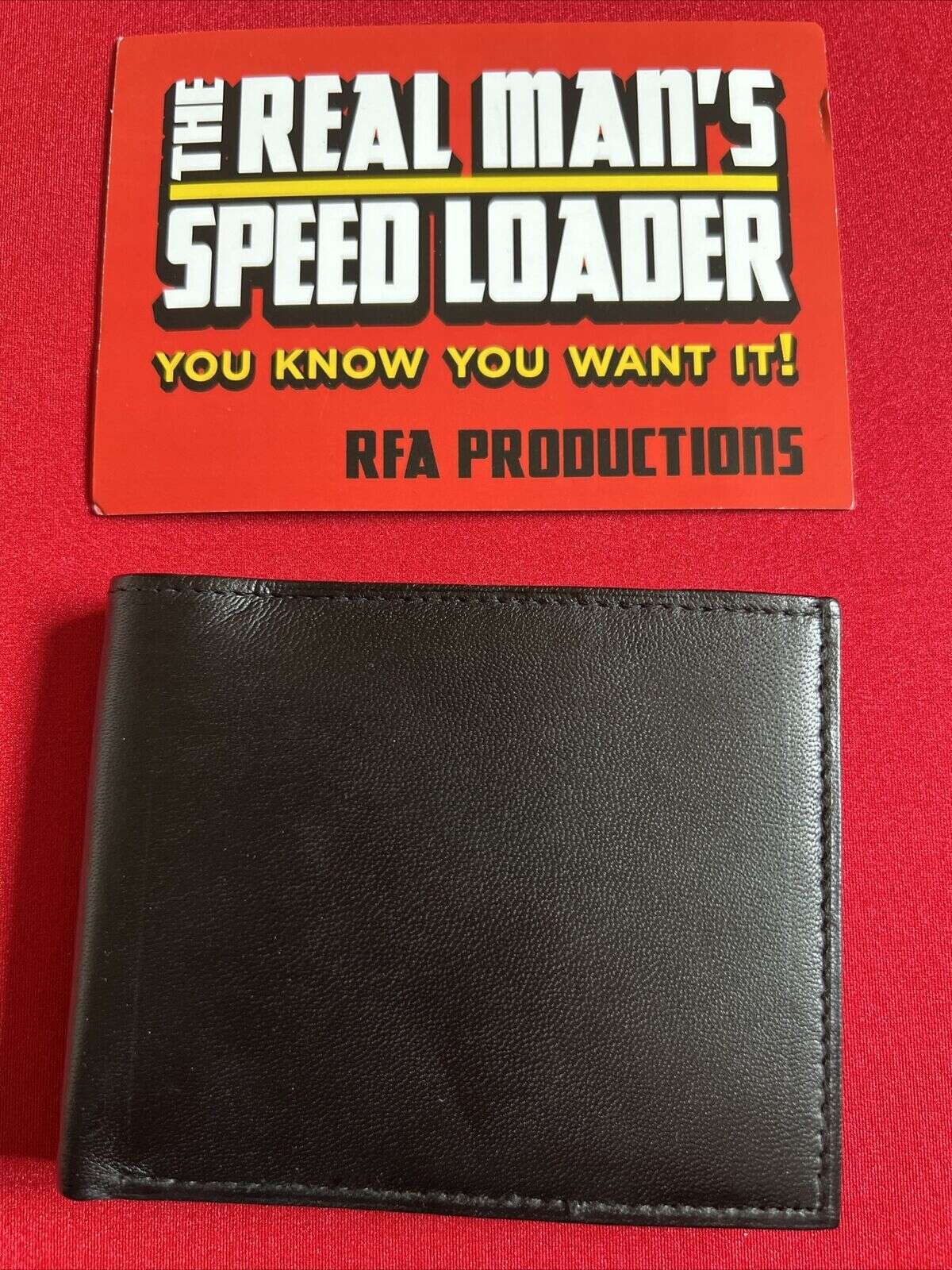 The Real Man’s Speedloader by RFA Productions shown closed under product packaging on red background