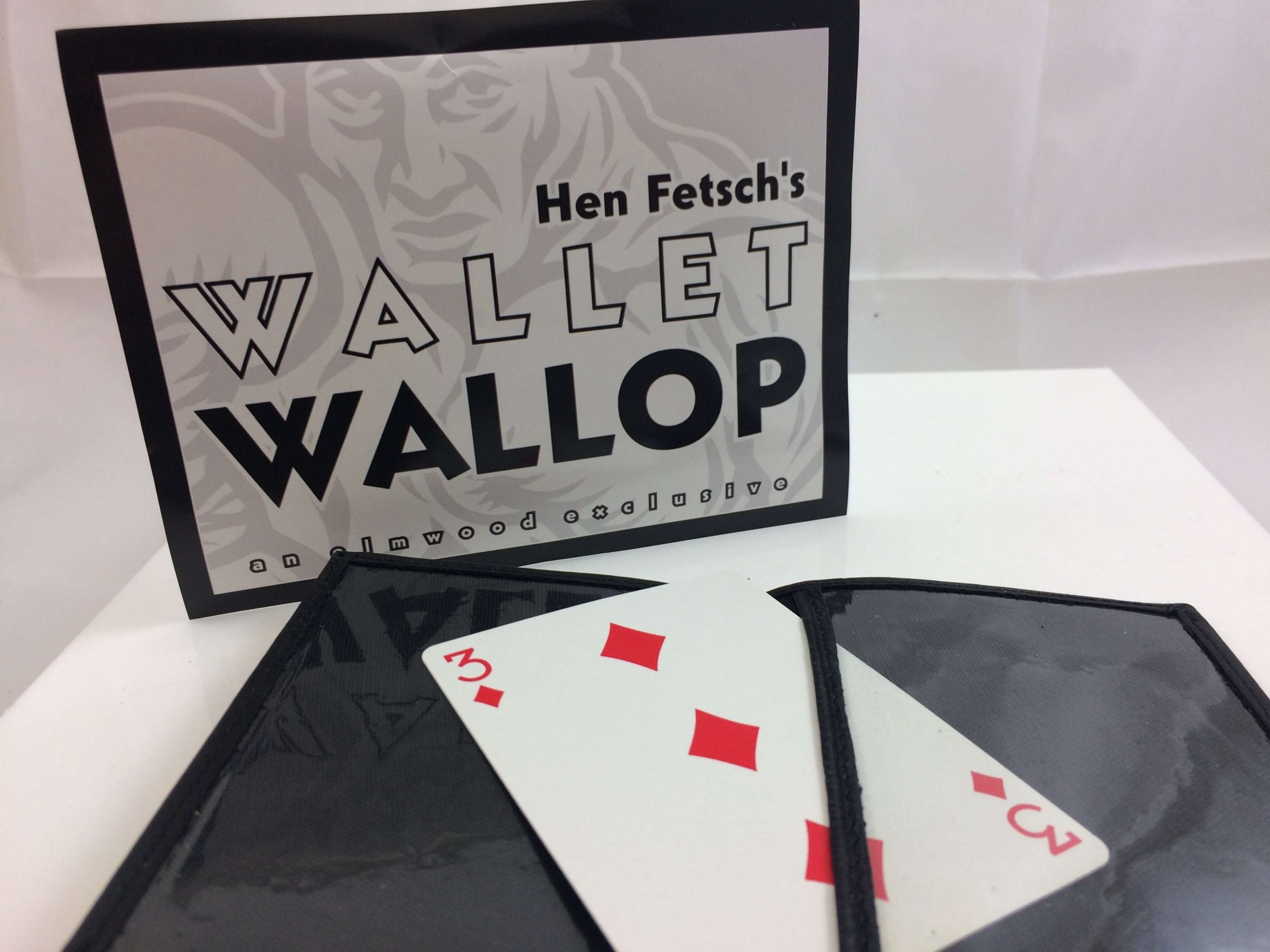 Wallet Wallop Trick by Hen Fetsch open with 3 of diamonds inside and product packaging in background