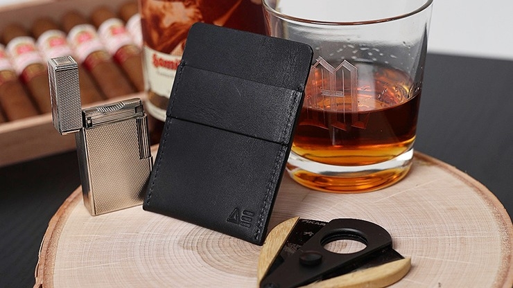 Wallet by Nicholas Lawrence next to zippo lighter and glass of alcohol