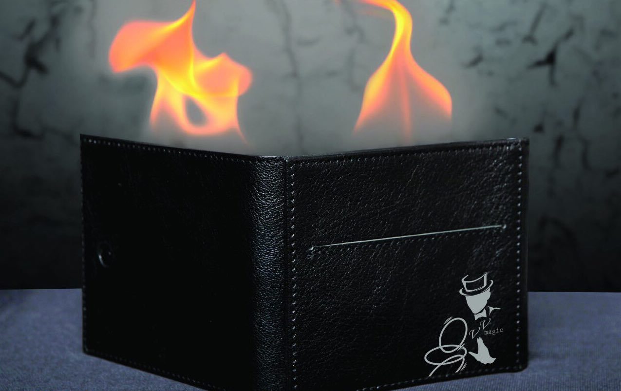 Perfect Fire Wallet by Viktor Voitko on fire standing on edge on a grey surface