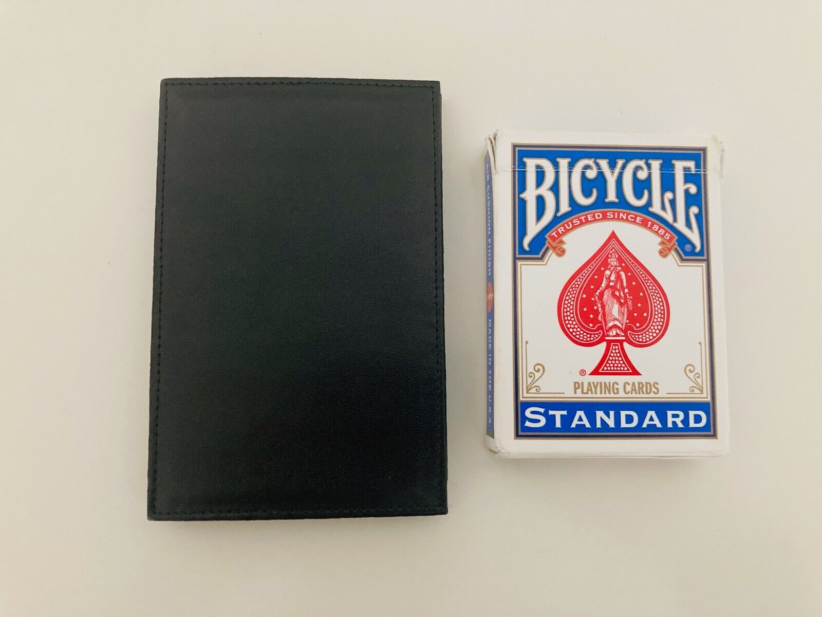 Larry Becker Insight Wallet shown closed next to Bicycle Cards Box